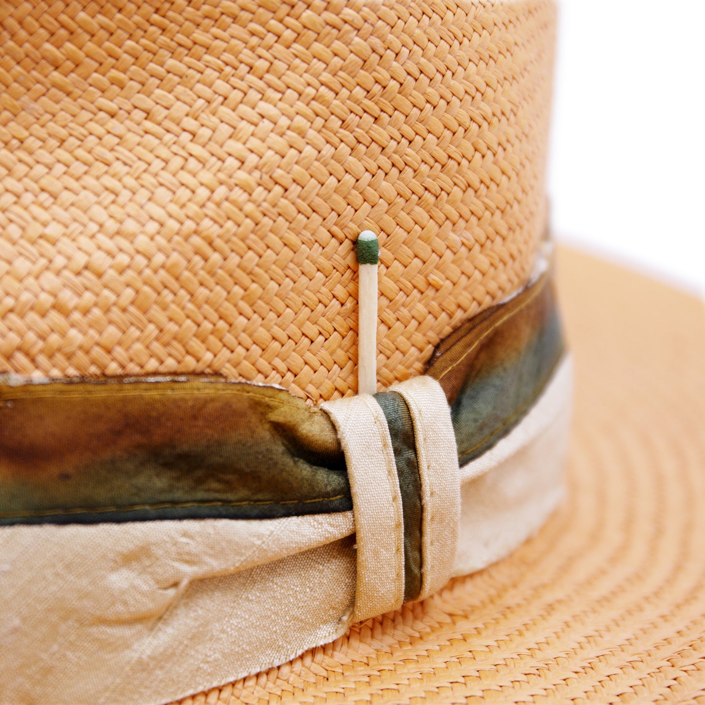 100% Ecuadorian straw hat in Pale Orange 2” Silk band with tie dyed silk binding Woven in Ecuador Flat brim Made in USA