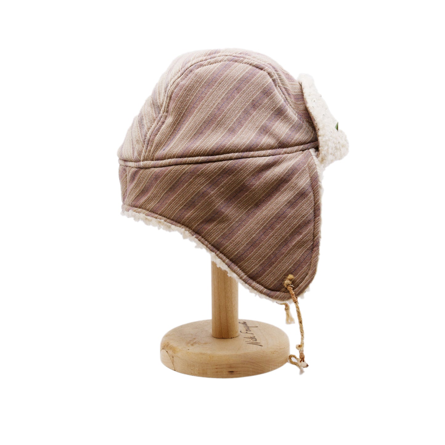 Snowmass Trapper Hat  Shearling Cotton   Braided twine and metallic button closure  Gold plated and ceramic accouterments will vary from hat to hat  Made in Los Angeles