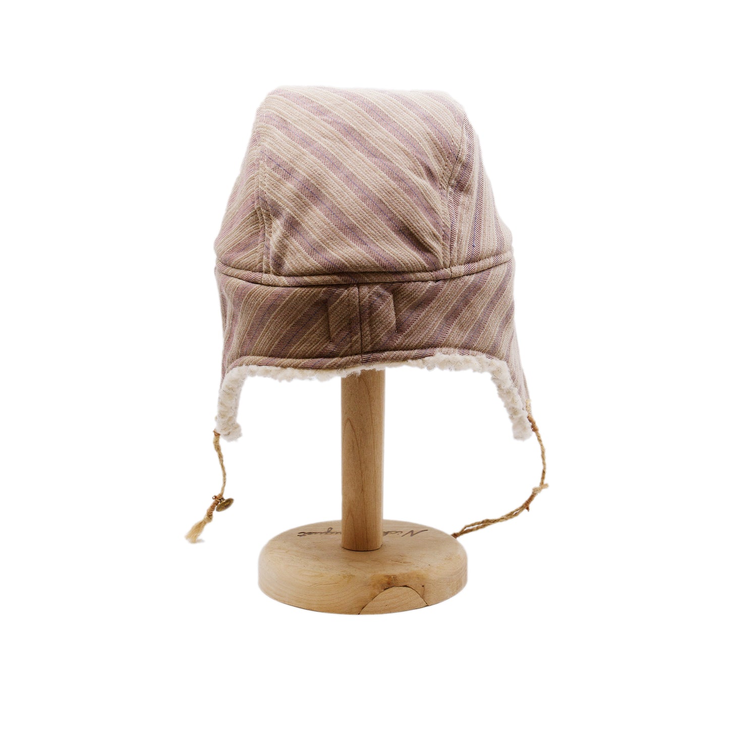 Snowmass Trapper Hat  Shearling Cotton   Braided twine and metallic button closure  Gold plated and ceramic accouterments will vary from hat to hat  Made in Los Angeles