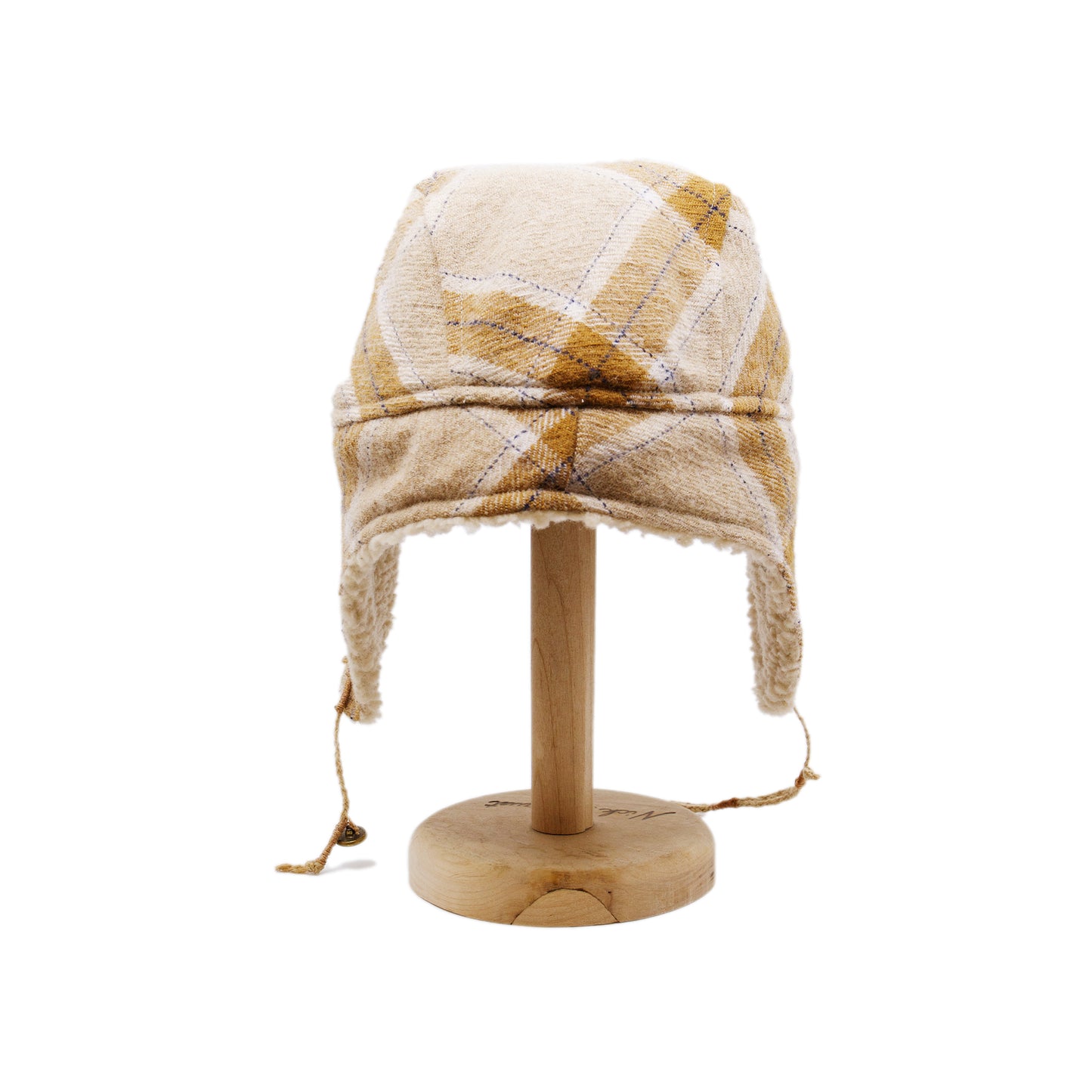 Buttermilk Trapper Hat Shearling Flannel Braided twine and metallic button closure Gold plated and ceramic accouterments will vary from hat to hat Made in Los Angeles