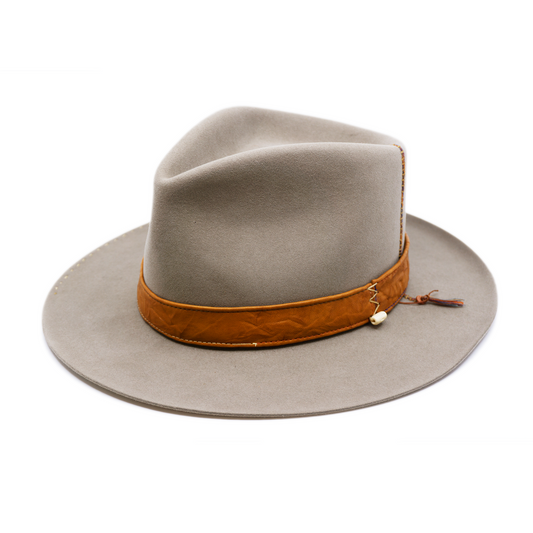 100% felt hat in Naturalll  Dress Weight   1” Caramel borello leather band   Brown tone threads with wax thread edge with cream bone beading  Multicolor hand stitching on crown   Back pencil curled brim  Made in USA 