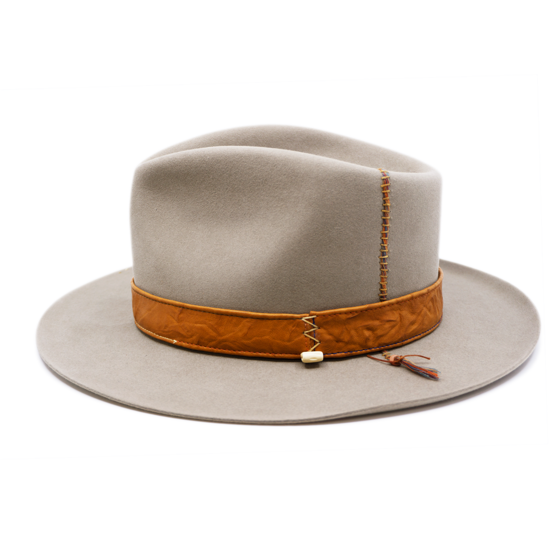 100% felt hat in Naturalll  Dress Weight   1” Caramel borello leather band   Brown tone threads with wax thread edge with cream bone beading  Multicolor hand stitching on crown   Back pencil curled brim  Made in USA 