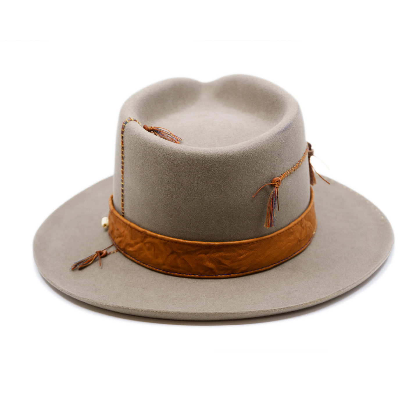 100% felt hat in Naturalll  Dress Weight   1” Caramel borello leather band   Brown tone threads with wax thread edge with cream bone beading  Multicolor hand stitching on crown   Back pencil curled brim  Made in USA 