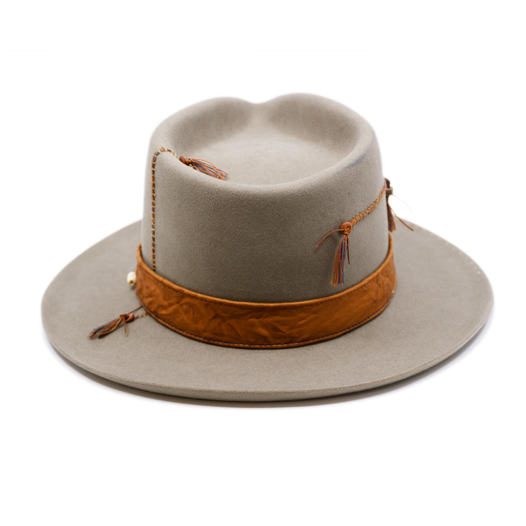 100% felt hat in Naturalll  Dress Weight   1” Caramel borello leather band   Brown tone threads with wax thread edge with cream bone beading  Multicolor hand stitching on crown   Back pencil curled brim  Made in USA 