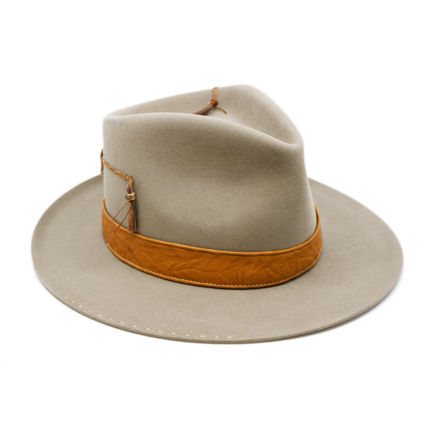 100% felt hat in Naturalll  Dress Weight   1” Caramel borello leather band   Brown tone threads with wax thread edge with cream bone beading  Multicolor hand stitching on crown   Back pencil curled brim  Made in USA 
