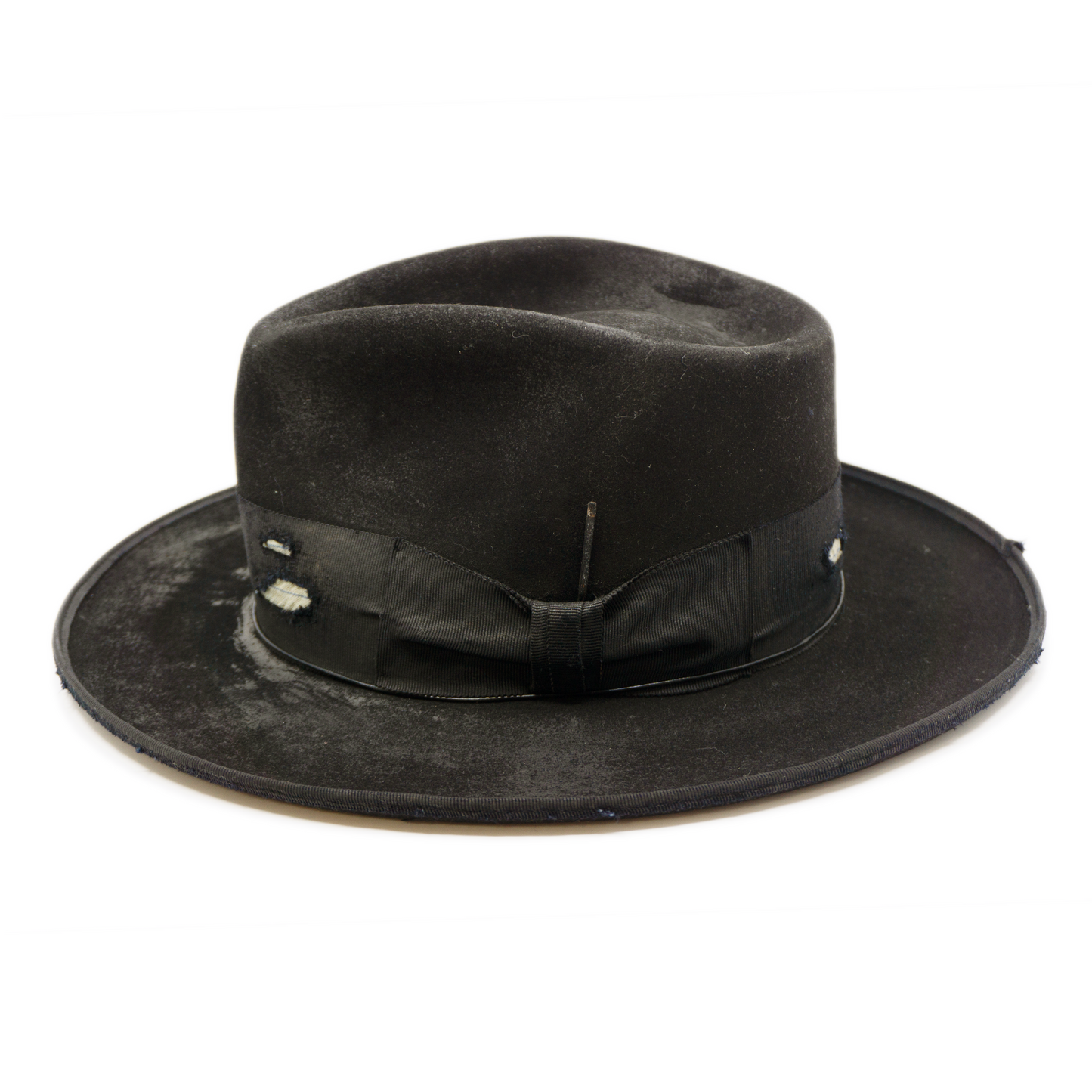 100% felt hat in Blackout  Western  Weight    2” distressed double layered band and bow  Distressed   Engraved NF silver matchstick   Holder in leather pocket   12mm distressed binding  Pencil curled  brim  Made in USA