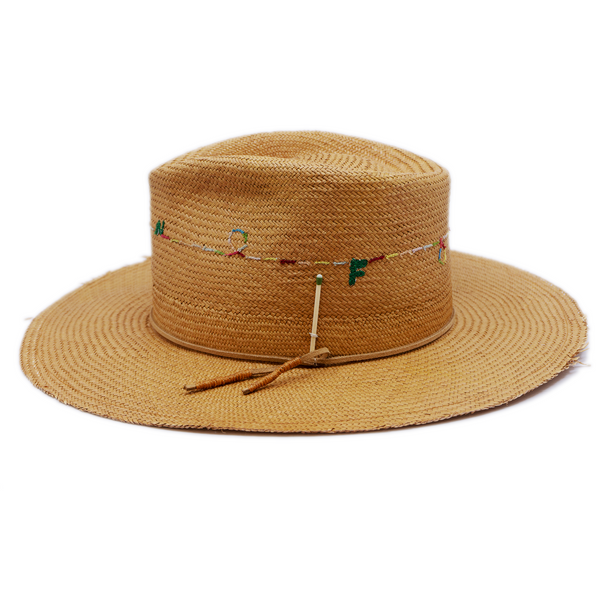 100% Ecuadorian straw in Natural Brown  Suede cord with japanese wax   thread ends band  Multicolor N—-F embroidery around crown   Woven in Ecuador  Lightly frayed brim  Made in USA  