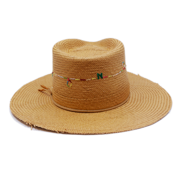 100% Ecuadorian straw in Natural Brown  Suede cord with japanese wax   thread ends band  Multicolor N—-F embroidery around crown   Woven in Ecuador  Lightly frayed brim  Made in USA  