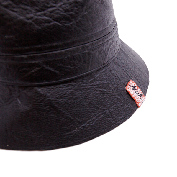 100%  Reishi™ bucket hat  MycoWorks Fine Mycelium™ leather alternative   Black edge binding  NF cloth swag clip  NF striped linen liner  Made in California