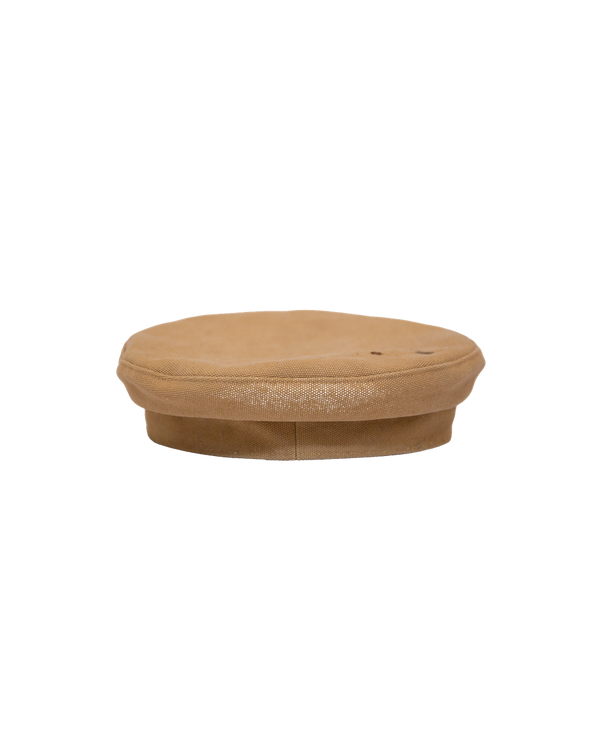 Side view of the Alcyon tan canvas flat cap with a vachetta brim.