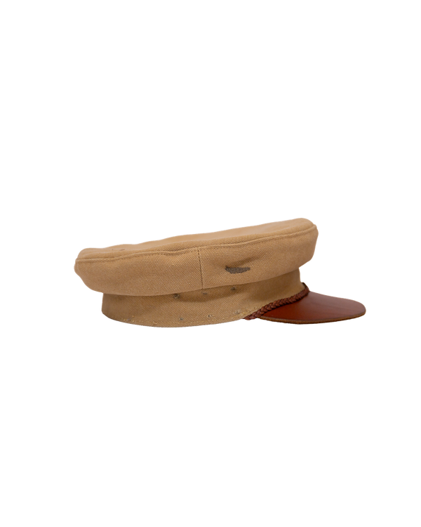 Alcyon tan canvas captain’s hat featuring a vachetta brim and braided cord trim.