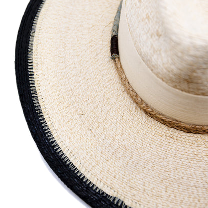 100% Mexican straw in Cream and Black  2" cream herringbone band and leather bow  Wrapped twine band  3 1/2"  Two-tone brim  Woven in Mexico  Subtle western flanged brim  Made in USA