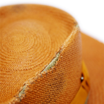 100%  Ecuadorian straw hat in Tangerine   2” tonal grosgrain and woven herringbone 2-ply band and bow  Distressed and inlay patchwork    Woven in Ecuador  Wavy brim   Made in USA 