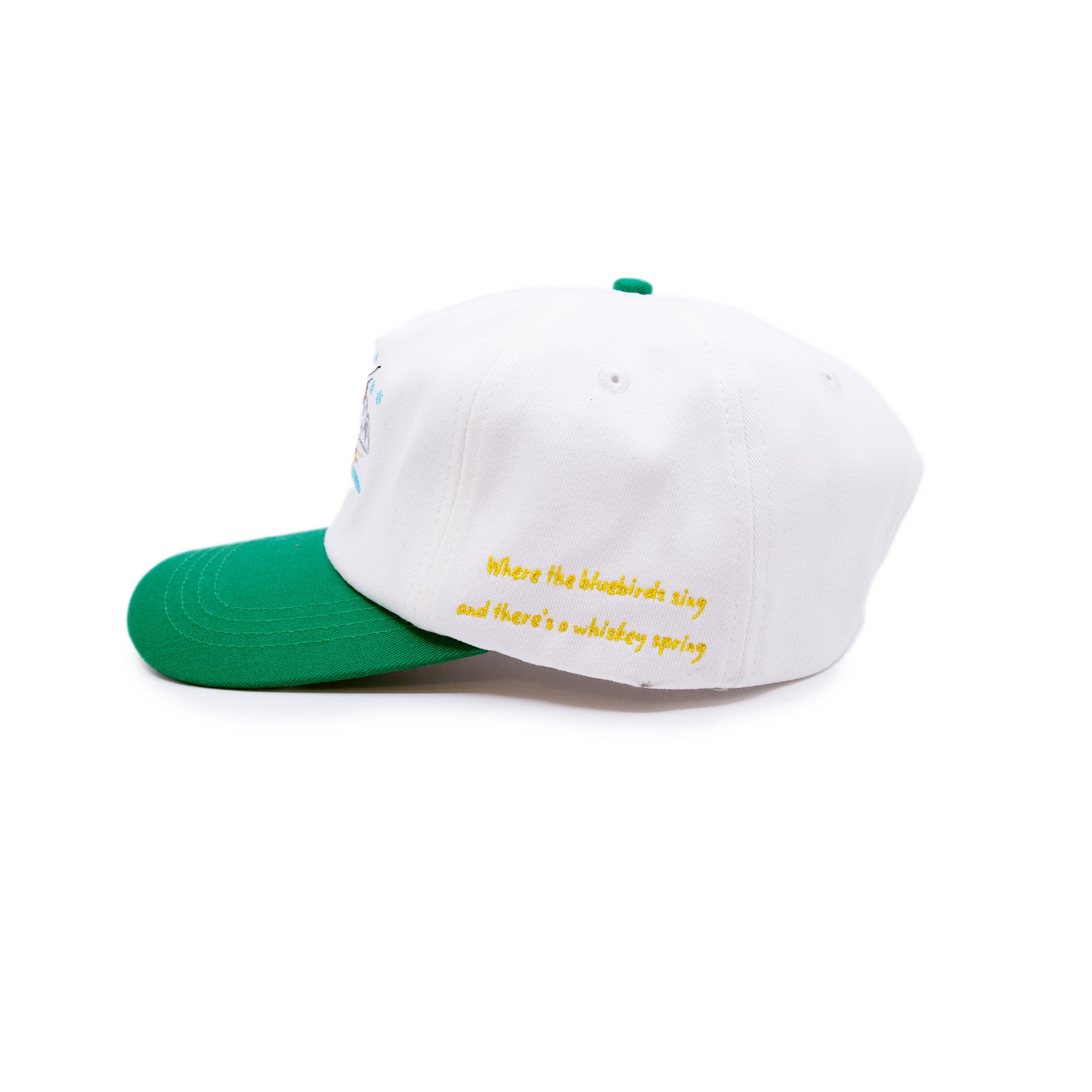 Aspen Tourist Cap  100% cotton in Cream/Green  Multicolor Embroidered 'Aspen' graphic  Yellow embroidered “Where the bluebirds sing and there’s a whiskey spring” message on side  Embroidered matchstick on reverse side  One size fits all  Made in Los Angeles 