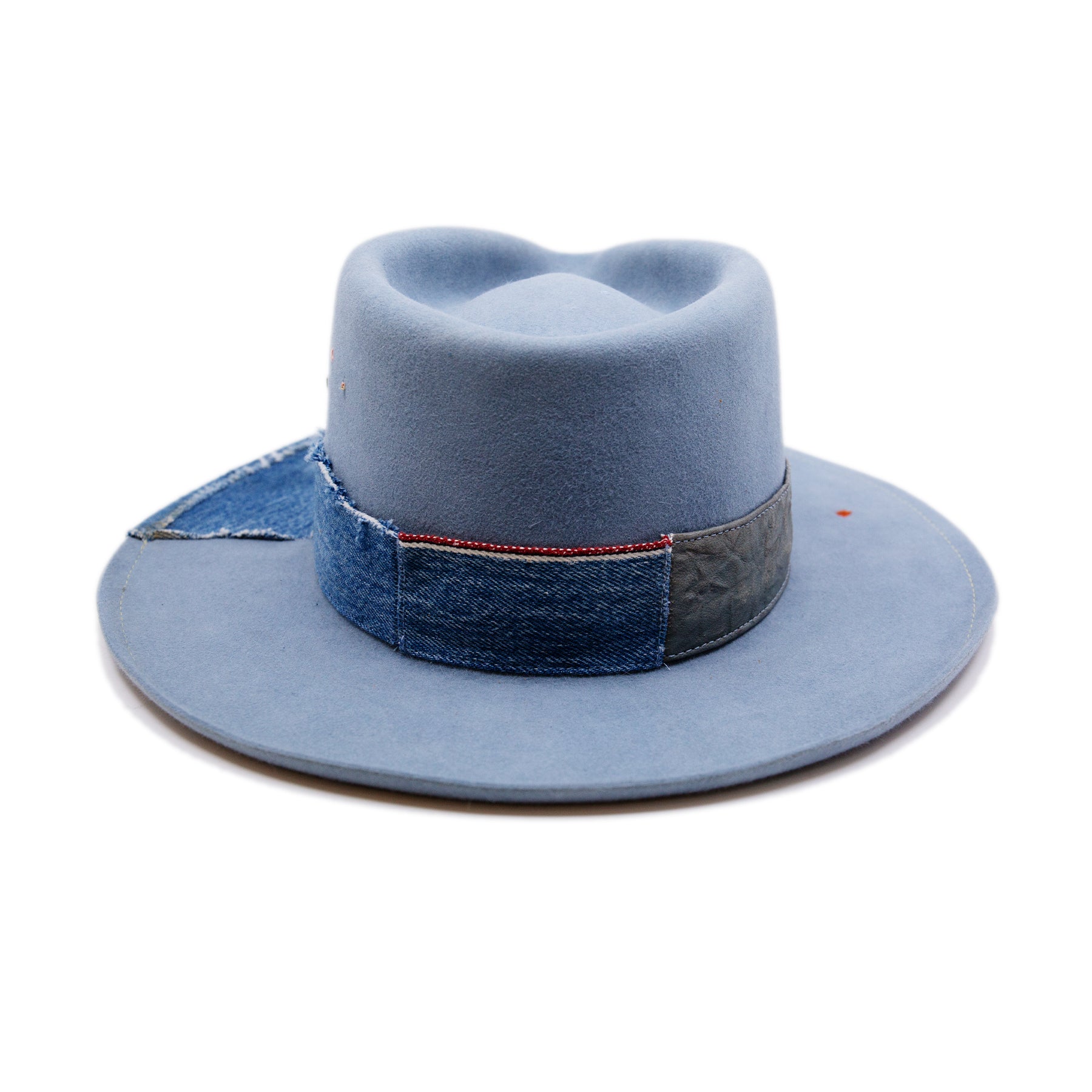 Lynn Hat  100% felt hat in Powder Blue  Dress Weight  Hand cut band from deadstock selvedge denim and calfskin leather  1/4" denim patch on brim with mending  1⁄4“ ticking on brim  Multicolor accent hand embroidery  Back pencil curled brim  Made in USA