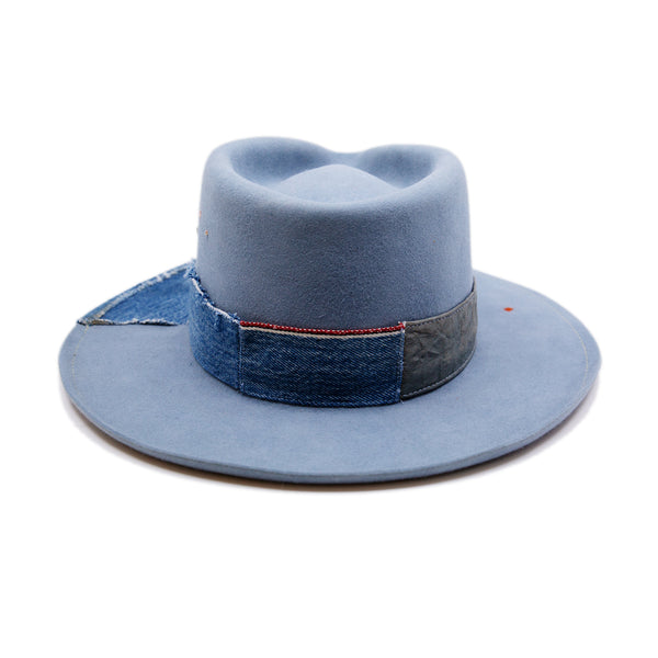 Lynn Hat  100% felt hat in Powder Blue  Dress Weight  Hand cut band from deadstock selvedge denim and calfskin leather  1/4" denim patch on brim with mending  1⁄4“ ticking on brim  Multicolor accent hand embroidery  Back pencil curled brim  Made in USA