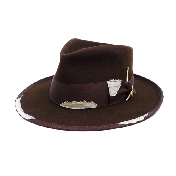 100% felt hat in Grizzly Brown   Western Weight   2” tonal grosgrain with NF fabric patchwork  Molt-harvested parrot feather with ceramic button   Full tonal binding with   NF fabric patchwork  Pencil curled back brim  Made in USA