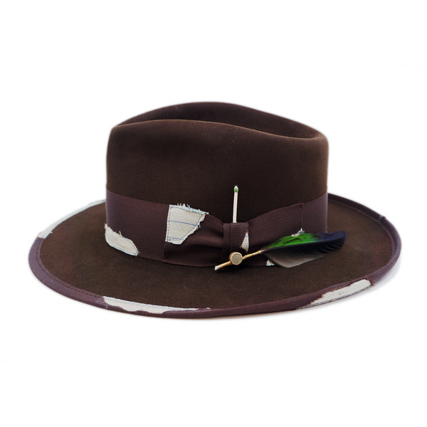 100% felt hat in Grizzly Brown   Western Weight   2” tonal grosgrain with NF fabric patchwork  Molt-harvested parrot feather with ceramic button   Full tonal binding with   NF fabric patchwork  Pencil curled back brim  Made in USA