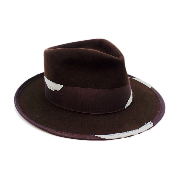 100% felt hat in Grizzly Brown   Western Weight   2” tonal grosgrain with NF fabric patchwork  Molt-harvested parrot feather with ceramic button   Full tonal binding with   NF fabric patchwork  Pencil curled back brim  Made in USA