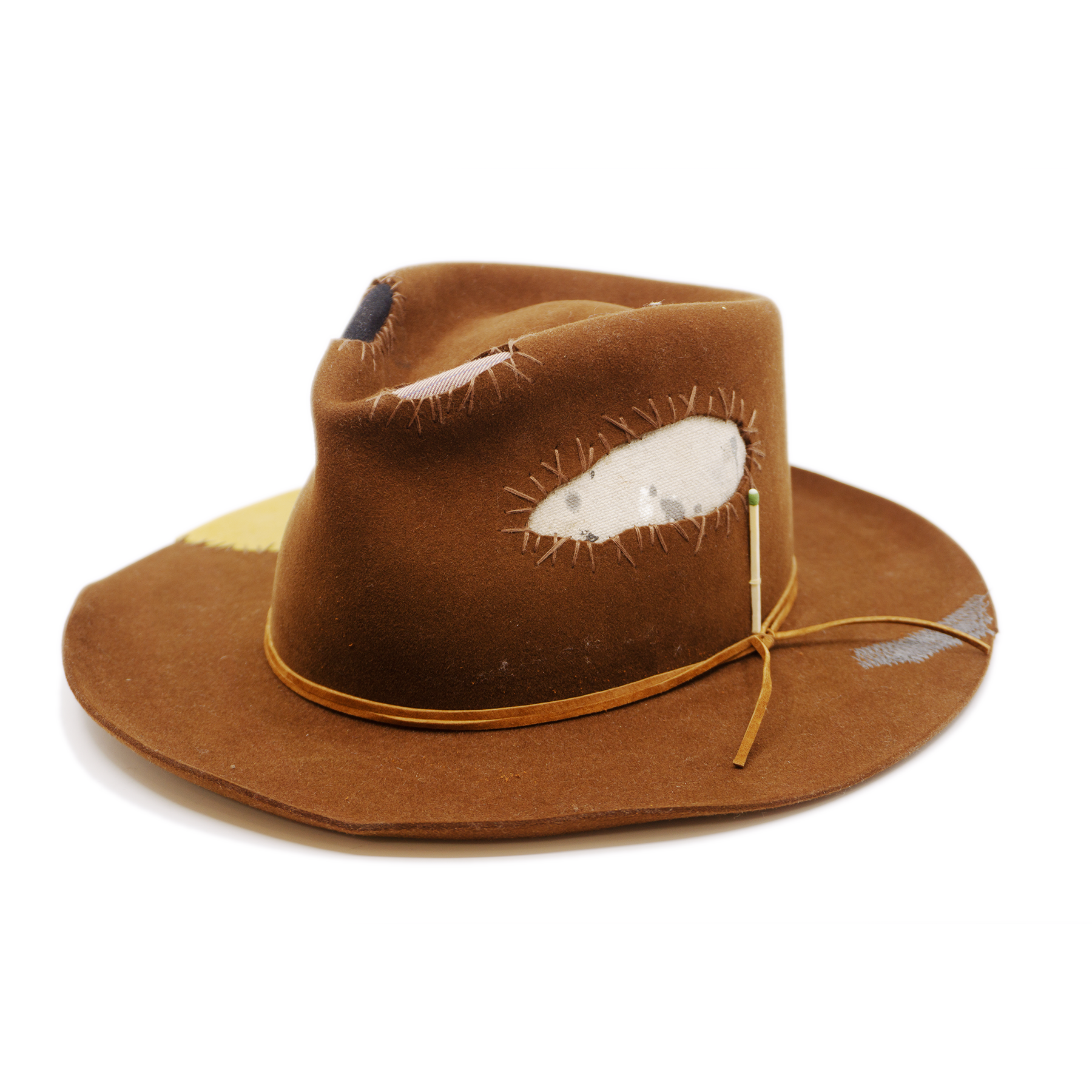 100% felt hat in Pimp Brown   Western Weight   Tonal suede lace wrapped twice   4 cut outs with two felt patches and two fabric patches  Tonal whip stitching   Wavy brim   Made in USA