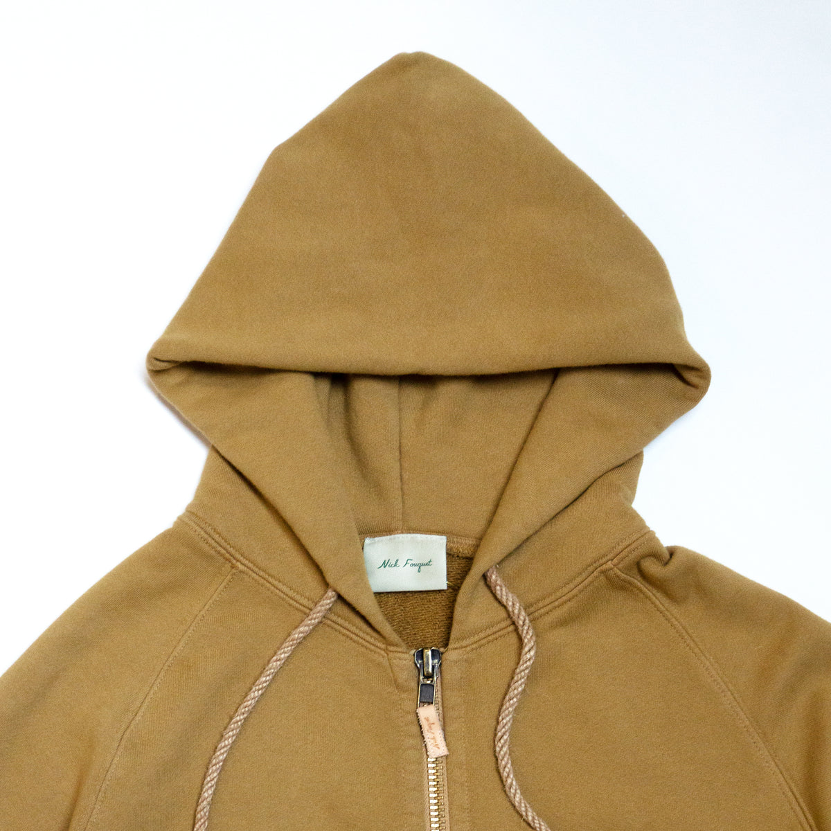 100% cotton french terry  Thick rib waistband and cuffs  Twine rope drawstrings with rubberized green ends  Oxidized brass zipper with embossed leather pull tab  Two front pockets  Matchstick embroidery  Made in Los Angeles
