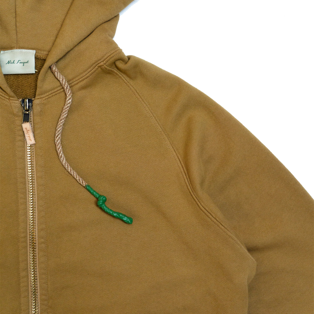100% cotton french terry  Thick rib waistband and cuffs  Twine rope drawstrings with rubberized green ends  Oxidized brass zipper with embossed leather pull tab  Two front pockets  Matchstick embroidery  Made in Los Angeles