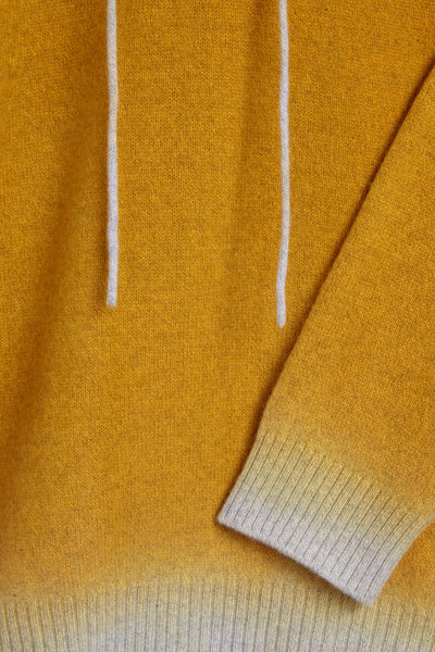 Nick Fouquet’s yellow Turi sweater made from wool and cashmere elevates the hoodie with a dip dyed ombre hem.  Yellow mid-weight cashmere wool hooded sweater Dip-dyed ribbed hem in cream Dip-dyed knit drawstrings at hood Composition: 90% virgin wool, 10% cashmere. Dry clean Country of origin: Italy