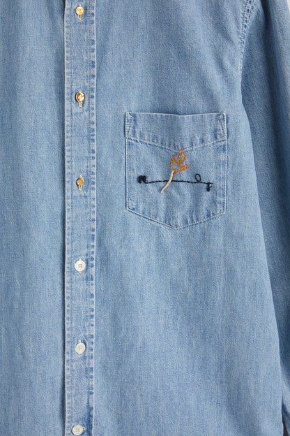 ULMANN SHIRT Light pastel blue chambray shirt Chest pocket with embroidered artwork Composition: 100% cotton Dry clean Country of origin: Italy