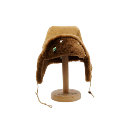 Aspen Highlands Trapper Hat Shearling Leather  Braided twine and metallic button closure  Gold plated and ceramic accouterments will vary from hat to hat  Made in Los Angeles