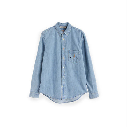 ULMANN SHIRT Light pastel blue chambray shirt Chest pocket with embroidered artwork Composition: 100% cotton Dry clean Country of origin: Italy