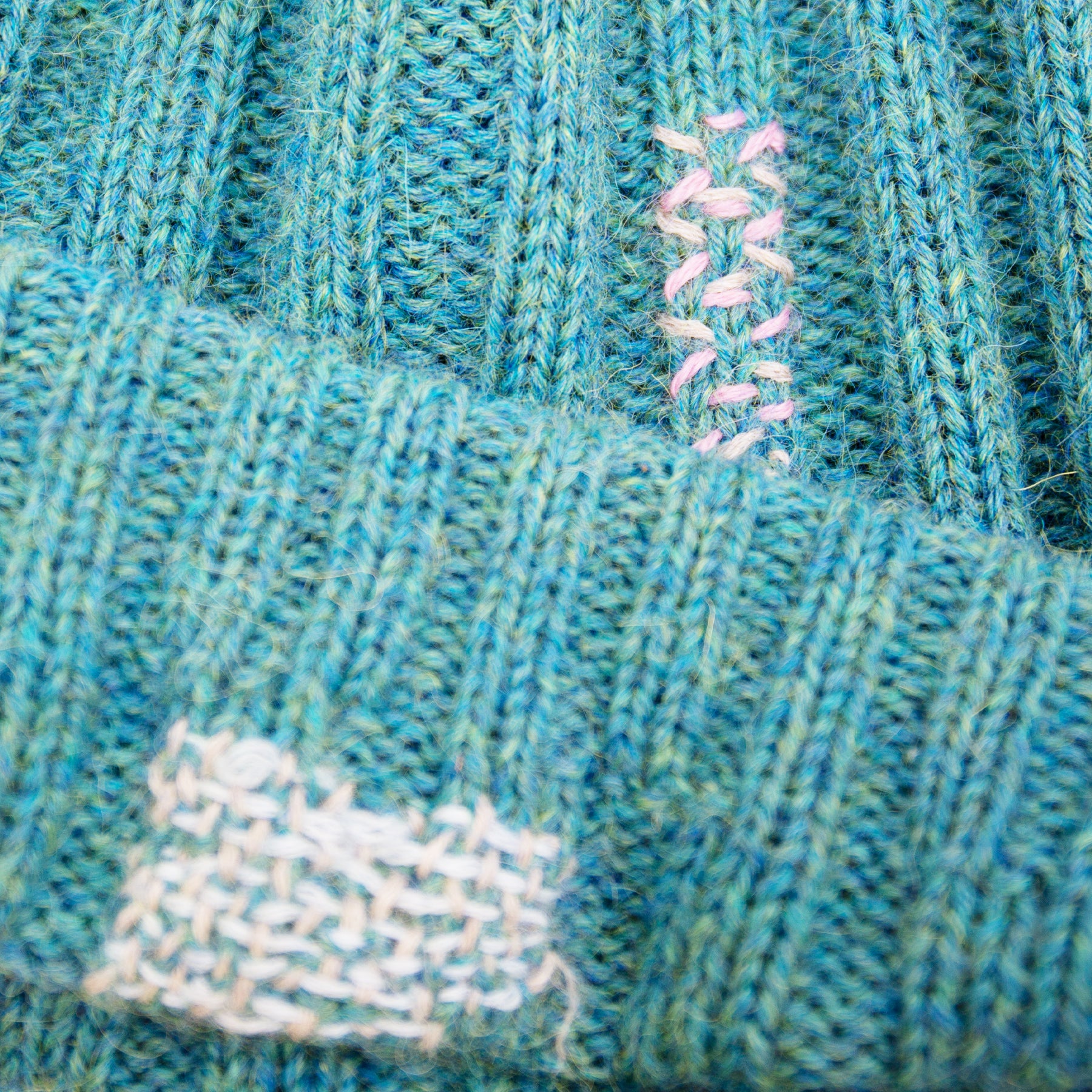 100% Baby Alpaca wool ribbed beanie in Pacific Ocean Blue  Multicolored hand-embroidered mending  Made in Los Angeles