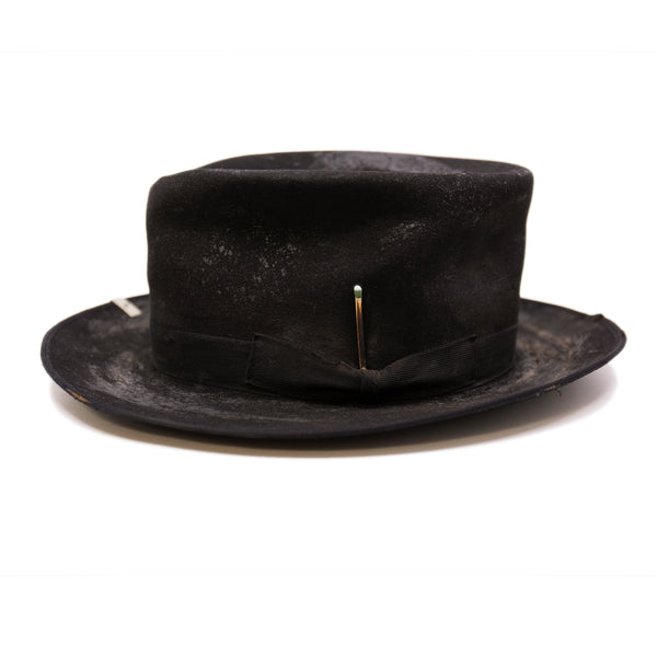 Nautholsvik  100% felt hat in Black   Dress Weight  1” tonal herringbone band & bow   Distressed and crushed  Stove top hat with baby binding    Silver NF swag clip    Flanged brim  Made in USA