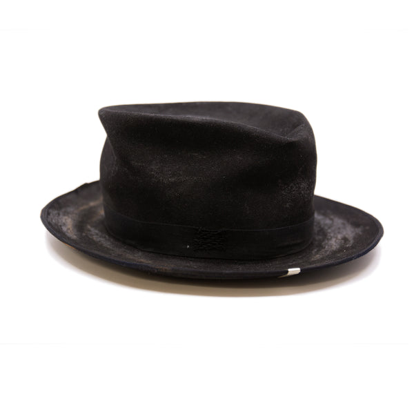 Nautholsvik  100% felt hat in Black   Dress Weight  1” tonal herringbone band & bow   Distressed and crushed  Stove top hat with baby binding    Silver NF swag clip    Flanged brim  Made in USA