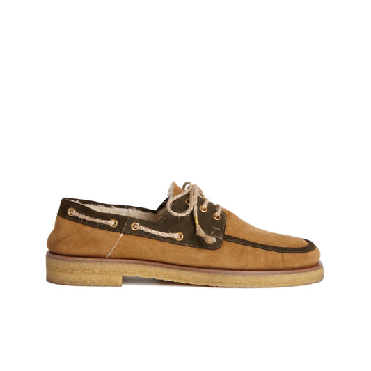 Shearling Boat Shoe - Brown Trim Fur lambskin boat shoes featuring dark brown trim Gold-tone eyelets Rope shoe laces with gold-tone embellishments Shearling lining Rubber sole Country of origin: Italy