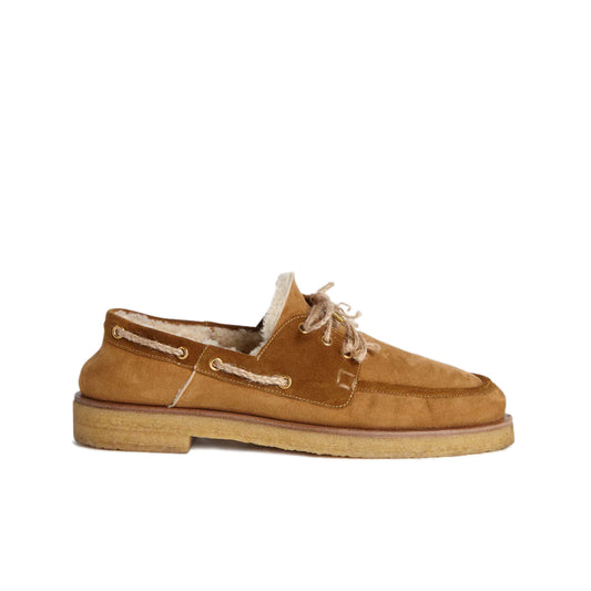 Shearling Boat Shoe - Tan Trim Fur lambskin boat shoes featuring tan trim Gold-tone eyelets Rope shoe laces with gold-tone embellishments Shearling lining Rubber sole Country of origin: Italy