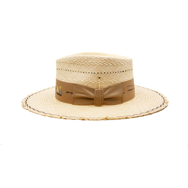Mehari  100% Ecuadorian straw in Natural  Special NF Weave  2" tan herringbone band and bow   Custom NF iconography in band  Zig zag stitching on brim   Woven in Ecuador  Frayed brim  Made in USA