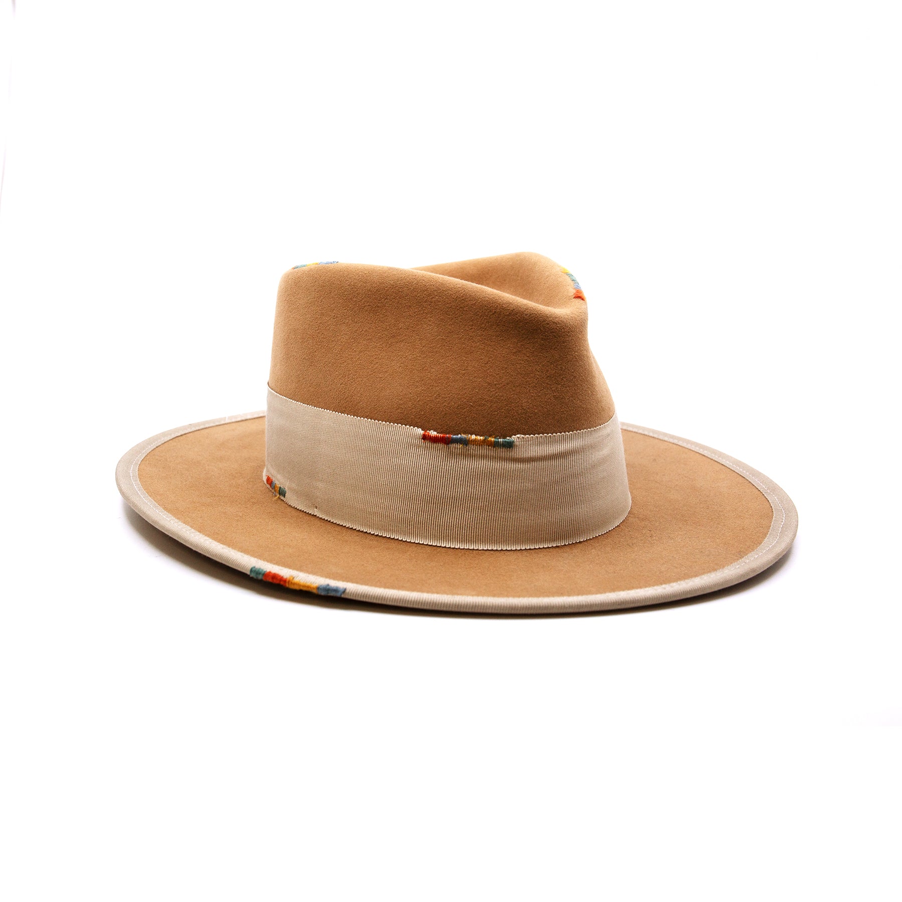 Phare Ouest  100% felt hat in Café Latte  Western Weight  2" tonal grosgrain band and double bow   Multi color handmade whip stitching throughout    Full binding  Flat brim  Made in USA